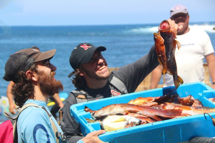 Happy men showing the captured fish