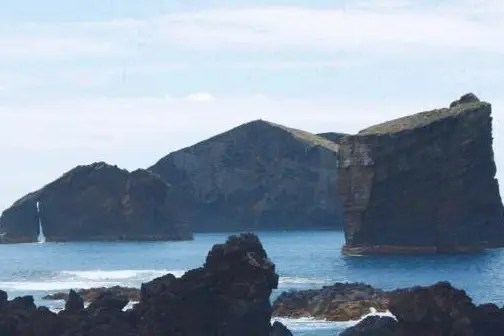 Rocky islands in blue ocean under clear sky