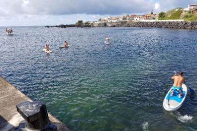 People practicing paddleboard in Mosteiros